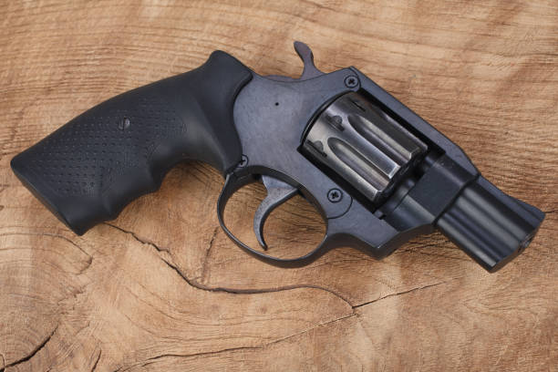 istock Revolver on the wooden table 1205369208