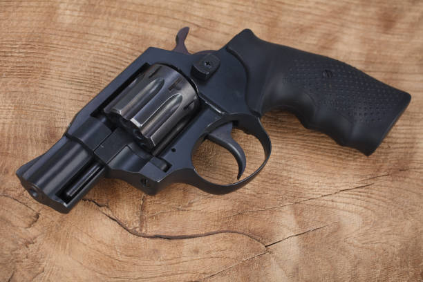 istock Revolver on the wooden table 1205369356