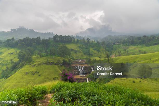Beautiful Waterfall Among Green Hills Under Cloudy Mountains St Clairs Falls Sri Lanka Stock Photo - Download Image Now