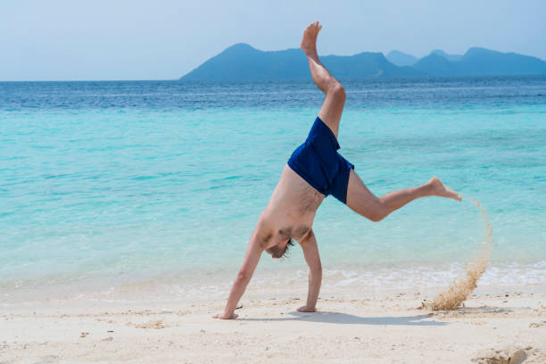 istock Men handstand in the sea 1205371875