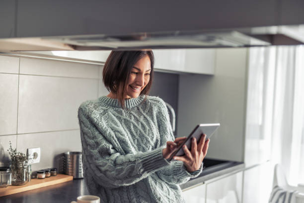 istock Business woman working on her tablet and drinking coffee 1205373097