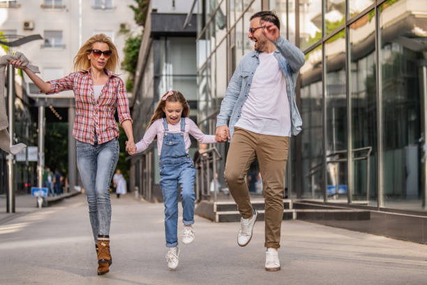 istock Happy young family of three smiling while spending time together 1205373500