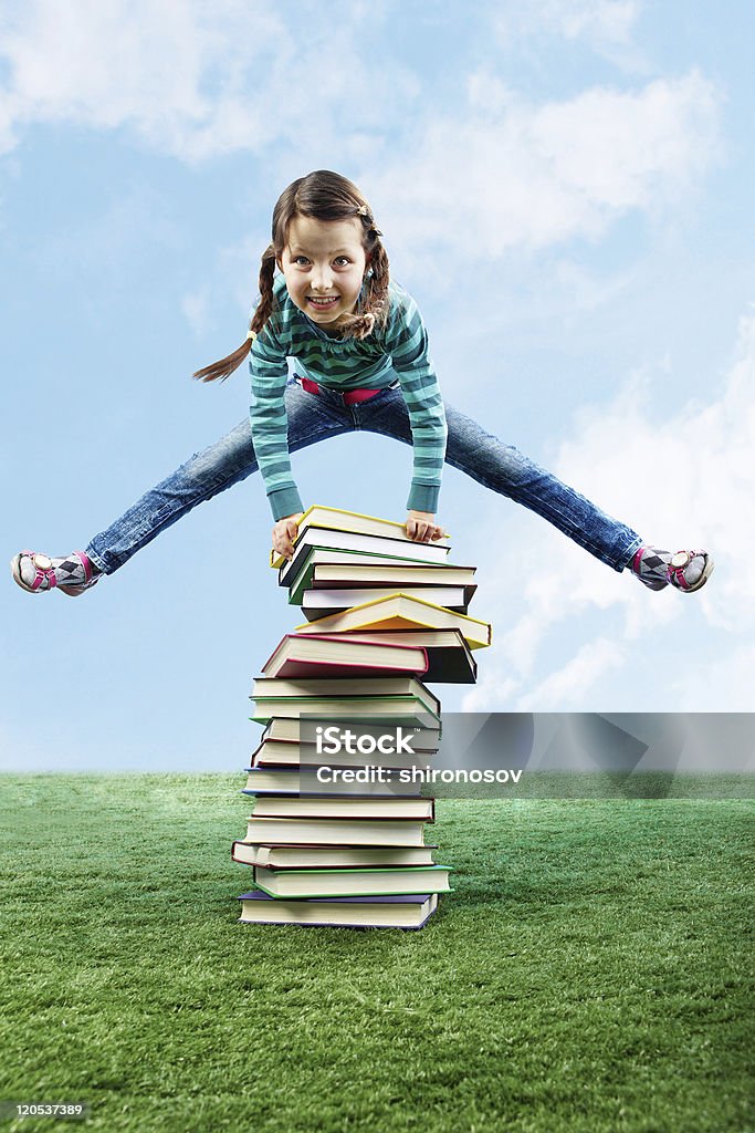 Leaping through stack  Book Stock Photo
