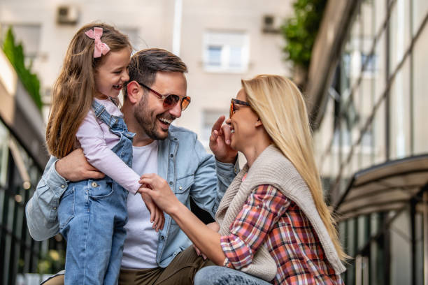 istock Happy young family of three smiling while spending time together 1205374231