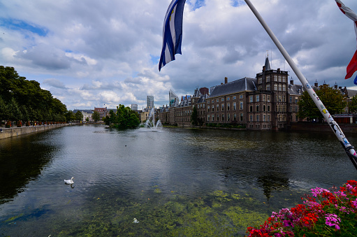 Holland, Den Haag. August 2019. The Hague in English, the Binnenhof is the center of Dutch political life. The buildings overlook the artificial lake with fountains and swans.