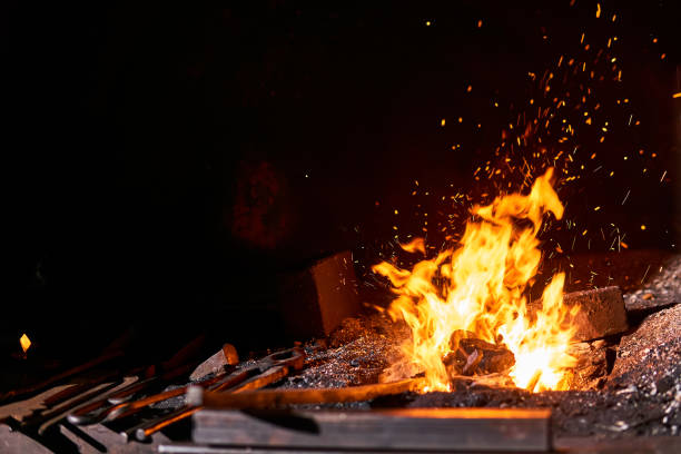 istock blacksmith furnace with burning fire and forging tools lying nearby 1205382197