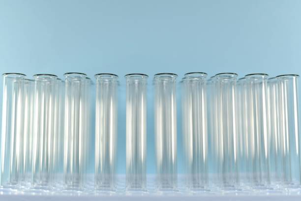 istock A few smooth rows of transparent glowing glare tubes fronted on a blue background in half on the stand. 1205383390