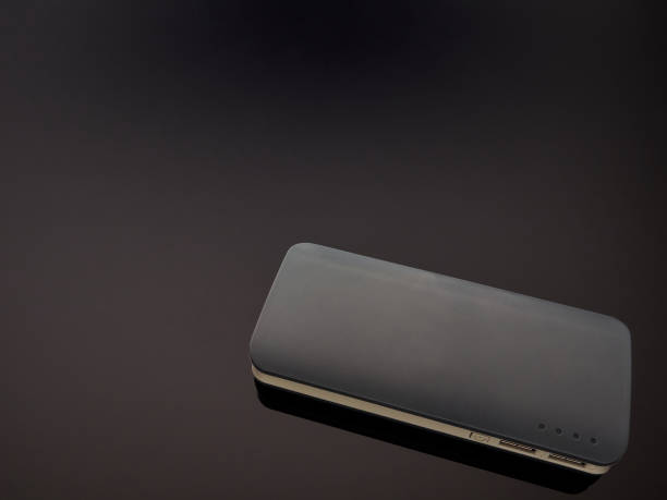 istock Gray mobile battery power bank on a gray gradient background 1205385709