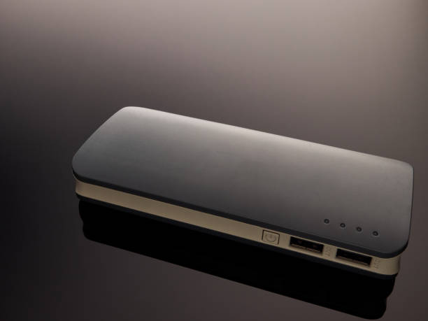 istock Gray mobile battery power bank on a gray gradient background 1205385717