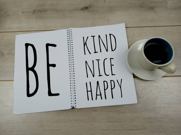 istock Be kind, be nice, be happy. Notes on paper book with morning coffee. 1205385904