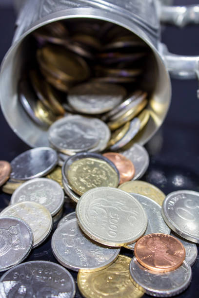 istock old coins that fell out of an overturned cup 1205391179