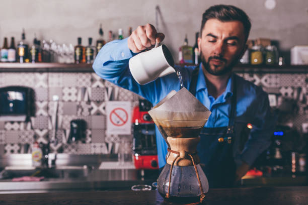 istock Male barista making filter coffee 1205391267