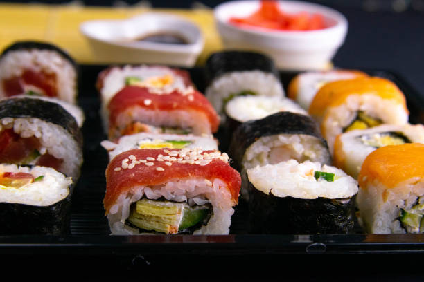 istock Different kinds of rolls stand on a black plate that stands on a black background 1205391939