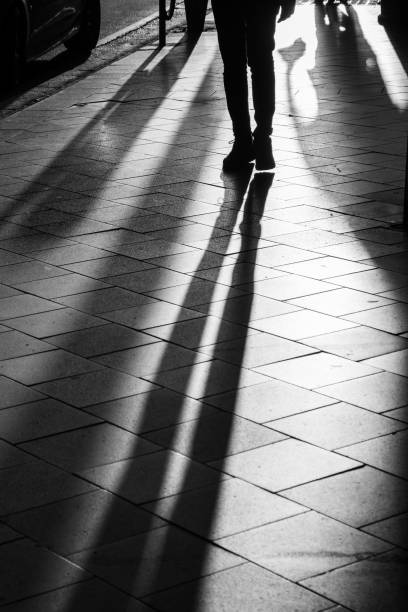 istock Long human shadows projected on the pavement at sunset 1205393330