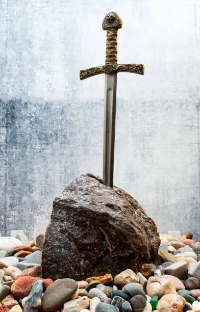 Excalibur, the mythical sword in the stone of King Arthur. Studio shot