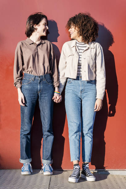 istock multiracial female couple looking at each other 1205401294