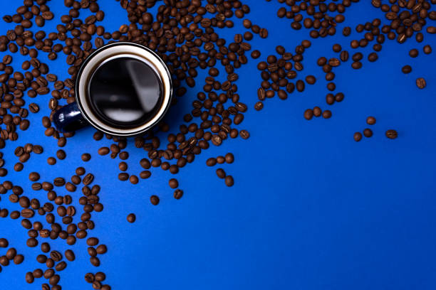 istock Top view of Cup of coffee on blue background 1205401430