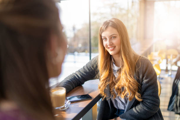 istock Two Women Sitting In Coffee Shop 1205401635