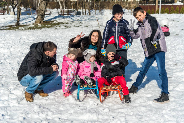 istock Happy family sledding on snow 1205401687