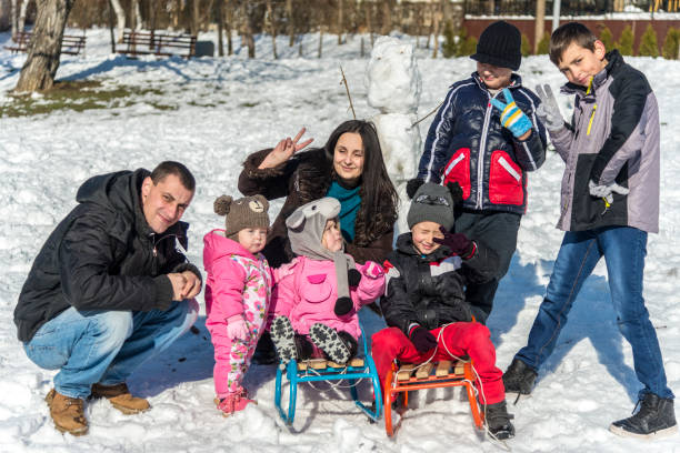 istock Happy family sledding on snow 1205401690