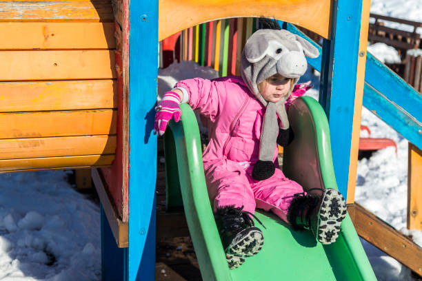 istock Happy children playing in the snow 1205401697