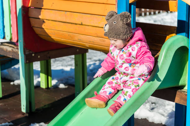 istock Happy children playing in the snow 1205401698