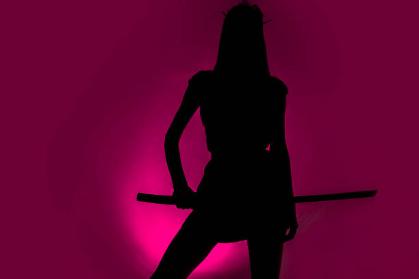 Silhouette ow sexy slim woman with samurai sword , purple background