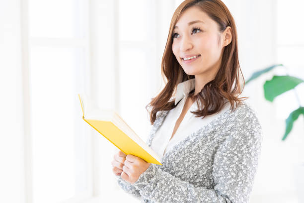 istock asian woman who reads a book 1205410445