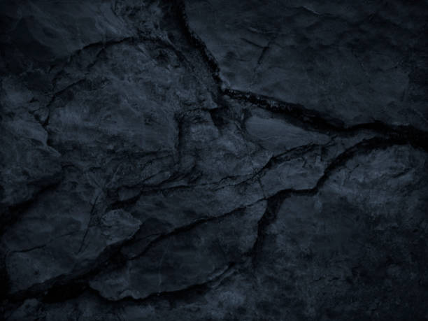 istock Black grunge background. Dark gray rocky texture with a cracked surface. Close-up. 1205412293