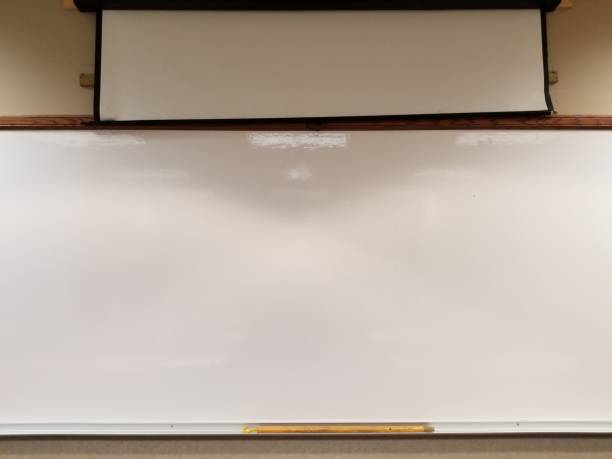 istock Blank glossy white board at front of classroom 1205412903