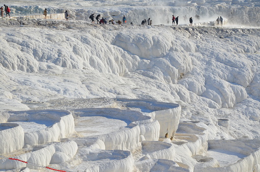 The calcium travertines at Pamukkale (Hierapolis), Turkey, near Denizli. Tourists can walk on the hot spring water travertine. Most of the Travertines are dry because of tourism.
