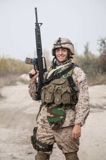 istock Equipped marine posing with service carbine rifle 1205419857