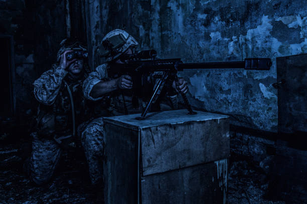 istock Army sniper team shooting with large caliber rifle 1205420047