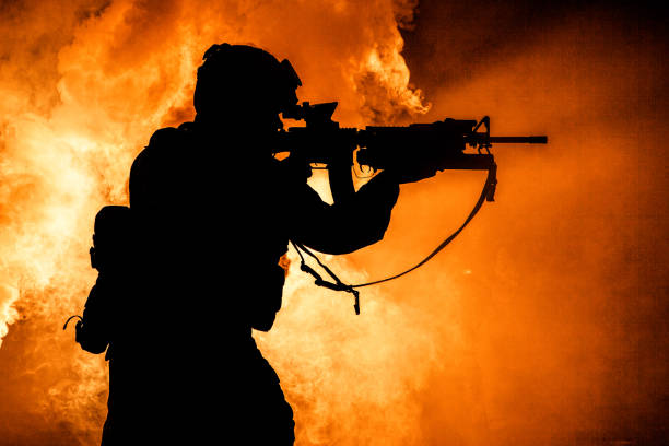 istock Soldiers silhouette on background of fire explosion 1205420087