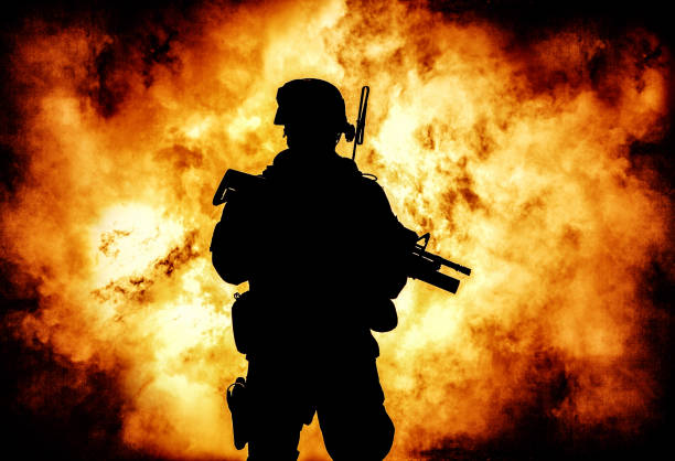 istock Soldiers silhouette on background of explosion 1205420091