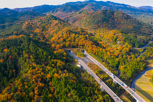 aerial view of traffic expressway of underground tunnel in mountain  of countryside, japan countryside expressway bridge and underpass road in autumn season change of Japan