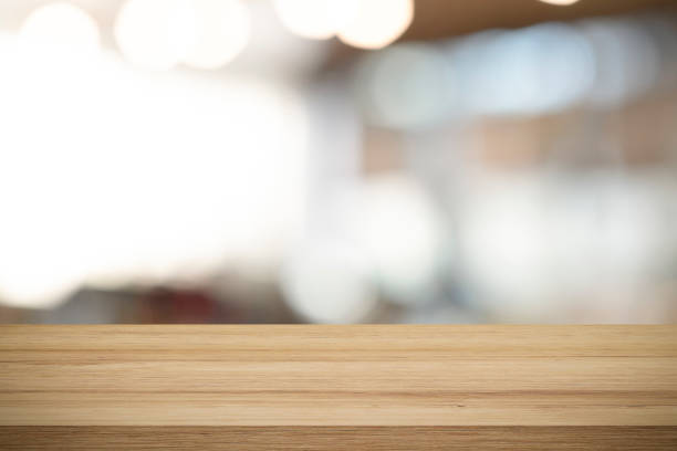 istock Empty wooden table for present product on coffee shop blur background. 1205424345