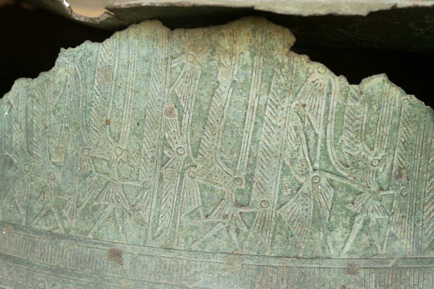 istock Primitive art craving on surface of ancient bronze drum. 1205430989