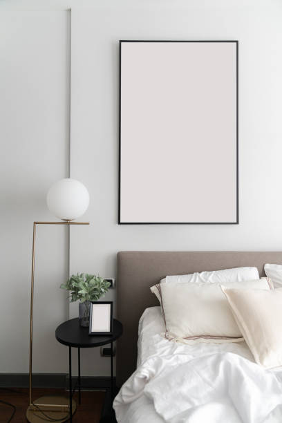 istock Cozy bedroom corner with modern brown fabric bed headboard and comfortable pillows  setting with gold lamp and artificial plant in glass vase on side table /Interior design decoration / copy space 1205432117