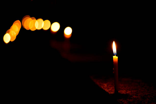 istock Candle with fire on top in the night time 1205437947