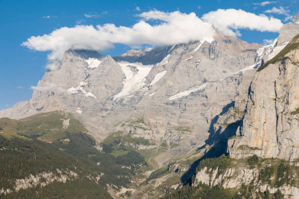 istock Bernese Alps panorama with Eiger glacier and cumulus clouds 1205438022