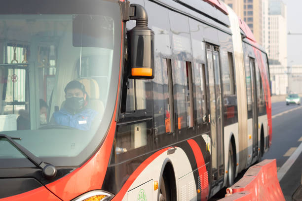 ChengDu China - Feb 11 2020: Since December 2019, Wuhan City, Hubei Province has found multiple cases of viral pneumonia, all of which were diagnosed with viral pneumonia / pulmonary infection.2019-nCoV coronavirus pneumonia in Wuhan has been spreading many cities in China.Chinese bus driver wearing surgical mask driving in ChengDu.