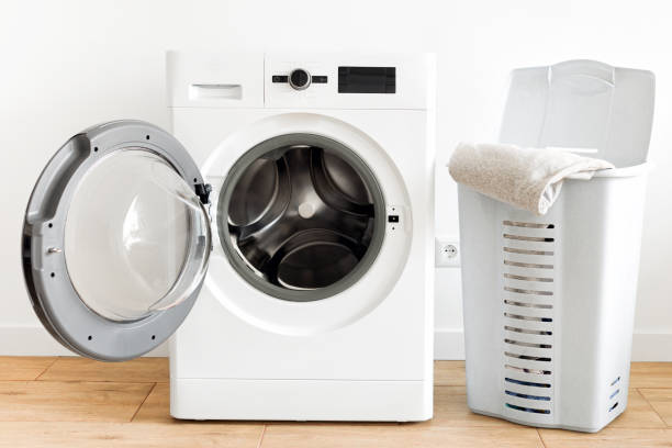 istock Washing machine with laundry basket in the home laundry room 1205439214