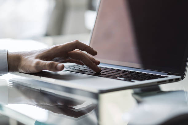 istock Businessman typing on a laptop, close up 1205440090