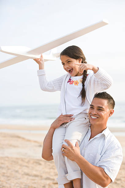 istock Hispanic father and daughter having fun on beach 120544206