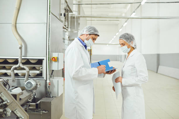 istock Technologists inspector in masks at food factory. 1205445876