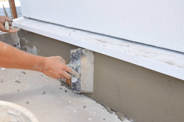 istock A contractor is plastering, repairing stucco house foundation after styrofoam insulation. 1205446910