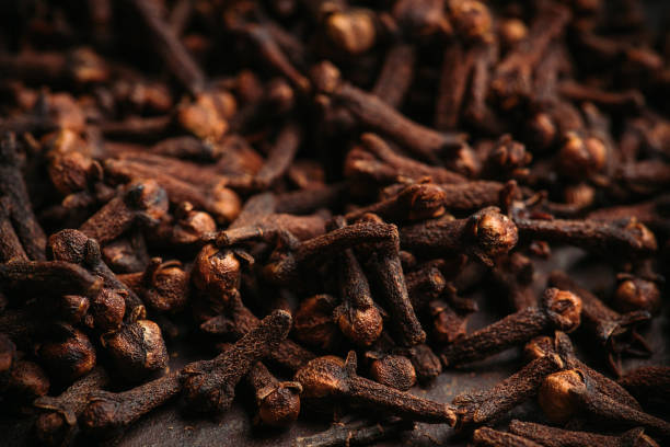 Dry cloves spices on the dark rustic background Dry cloves spices on the dark rustic background. Selective focus. shallow depth of field. clove spice photos stock pictures, royalty-free photos & images