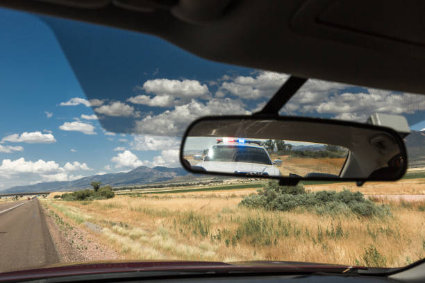 police pulling over vehicle on the streets - speeding ticket imagens e fotografias de stock