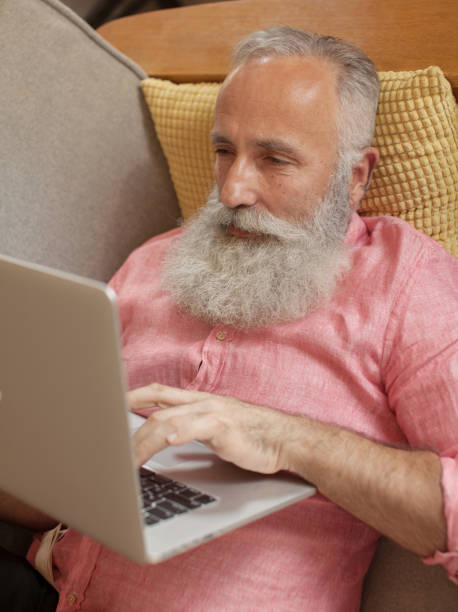 istock Senior man  at home and using laptop 1205449756